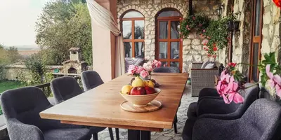 a wooden table with a bowl of fruit on it at къща за гости villa Jurta in Avren