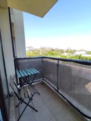 a balcony with a chair and a view of the city at Nelly's Place 10 in Shkorpilovtsi
