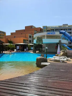 a swimming pool with a water slide in front of a building at Trakia Plaza Apartments in Sunny Beach