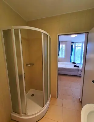 a shower with a glass door in a bathroom at Trakia Plaza Apartments in Sunny Beach