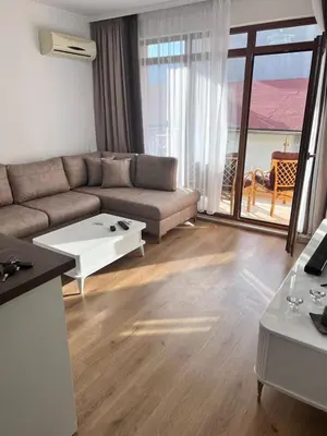 a living room with a couch and a table at Апартамент Дани in Obzor