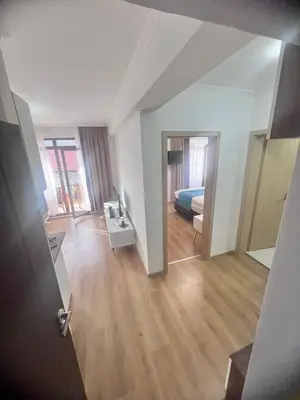 a view of a room with a bed and a hallway at Апартамент Дани in Obzor