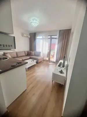 a living room with a couch and a table at Апартамент Дани in Obzor