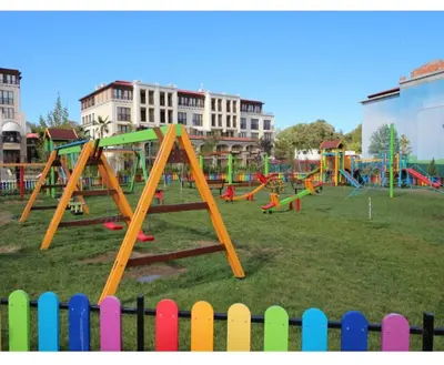 a playground with colorful play equipment in a park at Студио в Затворен Комплекс Green in Sozopol