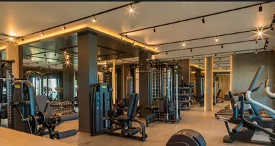 a gym with lots of exercise equipment in a building at Студио в Затворен Комплекс Green in Sozopol
