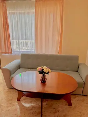 a living room with a couch and a coffee table at Vila Victoria Primorsko in Primorsko
