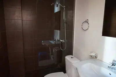 a bathroom with a shower and a toilet and a sink at SUN GATE - Julia in Sunny Beach