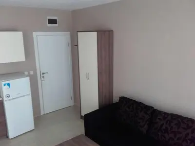a living room with a couch and a refrigerator at SUN GATE - Kamil in Sunny Beach
