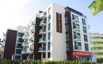 a large building with a sign on the side of it at SUN GATE - Kamil in Sunny Beach