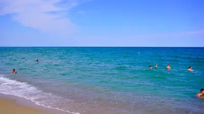 a group of people in the water at the beach at Апартамент Деа - Apartment Dea in Byala