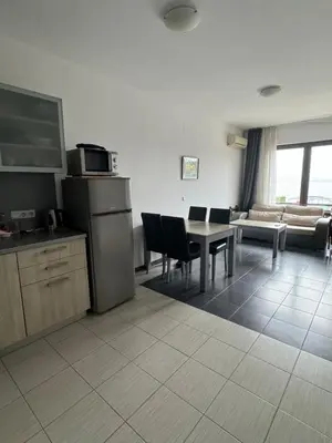 a kitchen and living room with a table and a couch at Relaxing apartment - 100 meters from the sea in Chernomorets