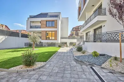 a house with a walkway in front of a yard at MAESTRA Bamboo Beach Luxury Apartment - FREE Parking in Sozopol