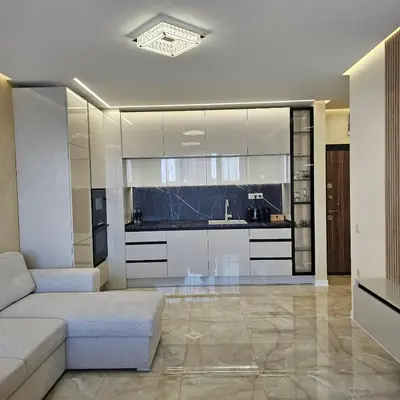 a living room with a couch and a kitchen at Арена Изгрев in Burgas City
