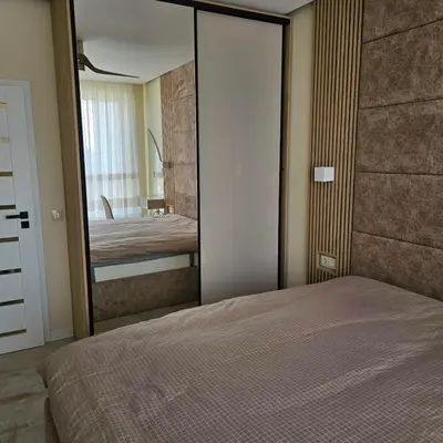 a bedroom with a mirror with a bed in it at Арена Изгрев in Burgas City