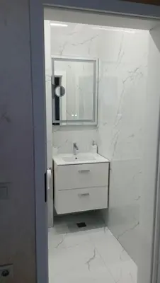 a white bathroom with a sink and a mirror at Арена Изгрев in Burgas City