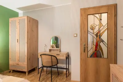 a bedroom with a desk and a chair and a door at Vera Sweet Home in Varna City