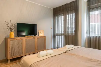 a bedroom with a bed with a flat screen tv at Vera Sweet Home in Varna City