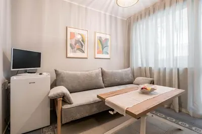 a living room with a couch and a table at Vera Sweet Home in Varna City