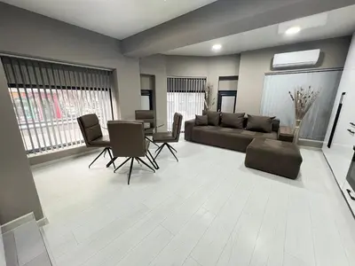 a living room with a couch and a table and chairs at NJ Modigliani style in Varna City