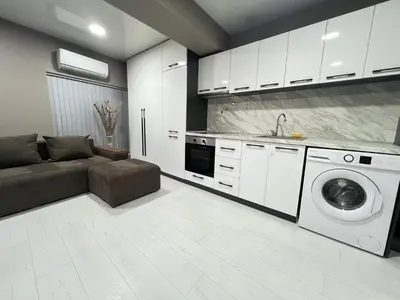 a kitchen with a couch and a washing machine at NJ Modigliani style in Varna City