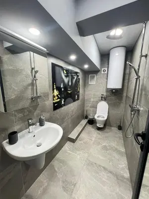 a bathroom with a sink and a toilet at NJ Modigliani style in Varna City