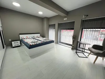 a bedroom with a bed and a couch and a chair at NJ Modigliani style in Varna City