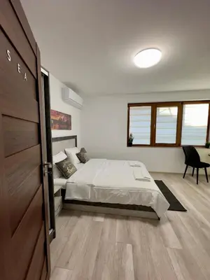 a bedroom with a bed and a sliding door at Sea in Varna City