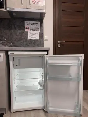 an empty refrigerator with its door open in a kitchen at Sea in Varna City