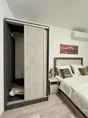 a bedroom with a large glass door next to a bed at Sea in Varna City
