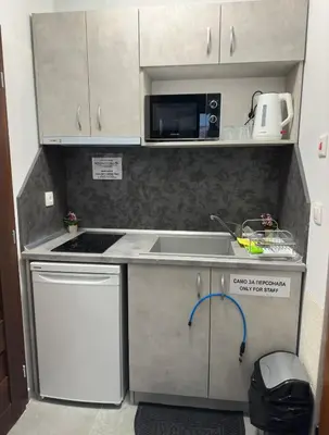a small kitchen with a sink and a microwave at Star in Varna City