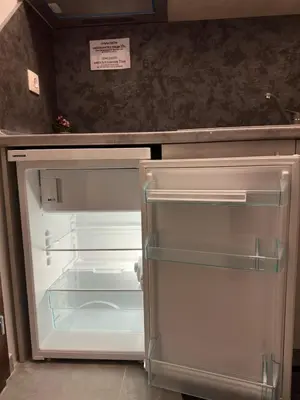 an empty refrigerator with its door open in a kitchen at Star in Varna City