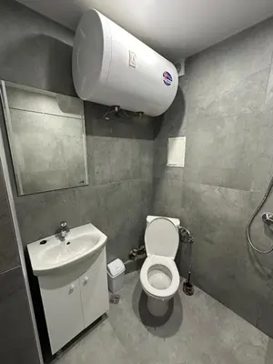 a bathroom with a white toilet and a sink at Star in Varna City