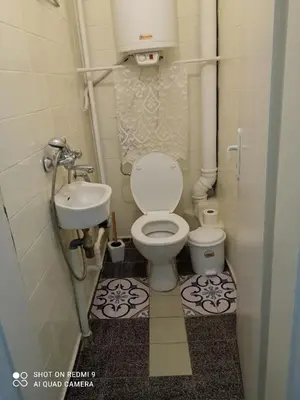 a small bathroom with a toilet and a sink at International 2-star spacious 88 sq m apartment in Varna City