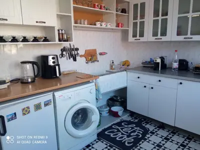 a kitchen with a washing machine and a counter at International 2-star spacious 88 sq m apartment in Varna City