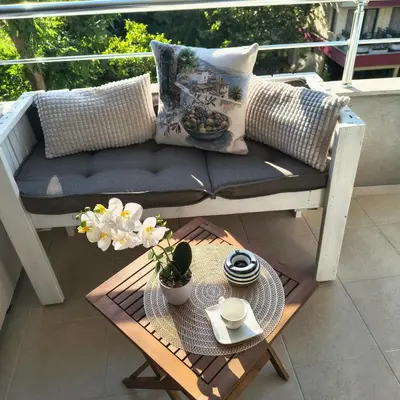 a porch with a bench and a table with at Slavi studios Aparthotel Exselsior, Sunny beach in Sunny Beach