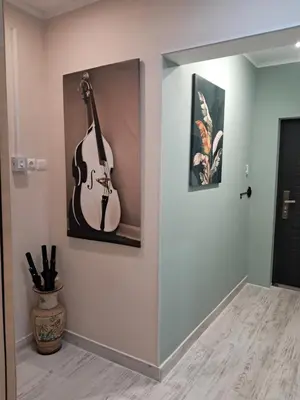 a guitar hanging on a wall in a room at Varna Moreto in Varna City