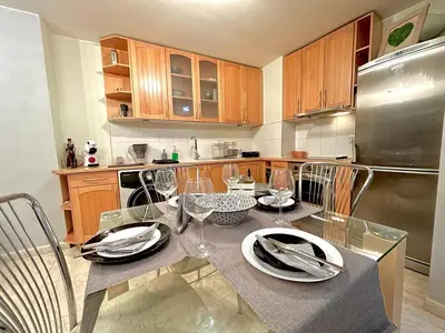 a kitchen with a table with wine glasses on it at Black Sea Varna Centre in Varna City