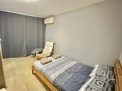 a bedroom with a bed and a chair at Black Sea Varna Centre in Varna City