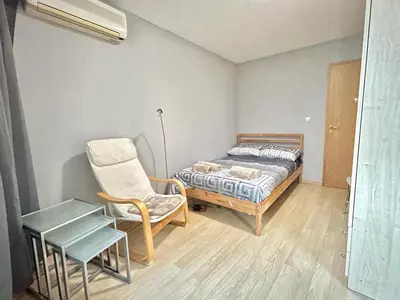 a bedroom with a bed and a chair and a table at Black Sea Varna Centre in Varna City