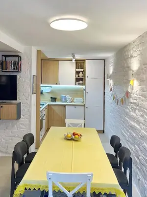 a dining room with a yellow table and chairs at Villa Mare Boutique Guesthouse by Flat Mаnаger in Pomorie