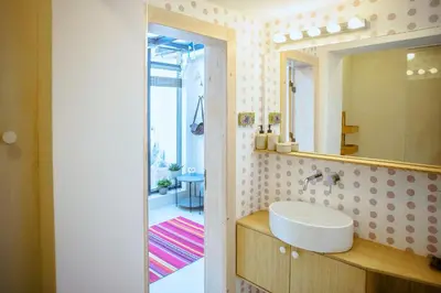a bathroom with a sink and a mirror at Villa Mare Boutique Guesthouse by Flat Mаnаger in Pomorie