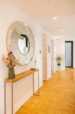 a room with a mirror on the wall and a table at Apartment Musala N 01 in Varna City