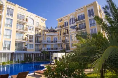 a large building with a swimming pool in front of it at Апартамент с одной спальней in Sunny Beach