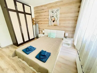a bedroom with a bed with blue pillows on it at Glarus in Varna City