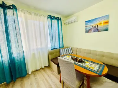 a living room with a table and a couch at Glarus in Varna City