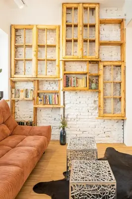 a living room with a brown couch and a brick wall at Apartment Musala N 02 in Varna City