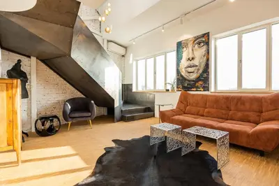 a living room with a couch and a staircase at Apartment Musala N 02 in Varna City