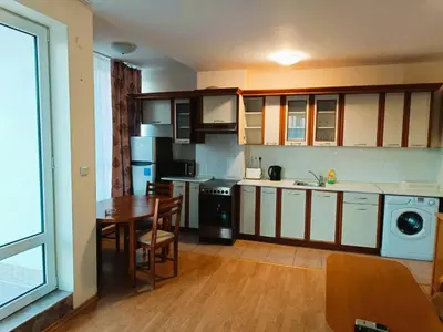 a kitchen with a table and a dining room at Riviera Fort Beach Apartment in Ravda