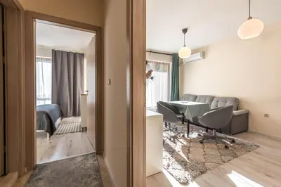 a living room with a table and a couch at Varna Beach Apartment in Varna City