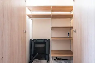 a room with a closet with wooden shelves at Varna Beach Apartment in Varna City